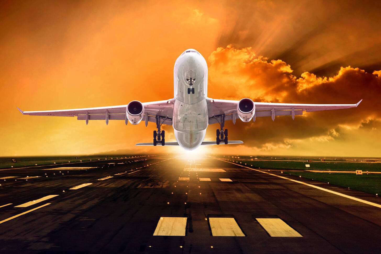 Airplane flying over mountains at sunset